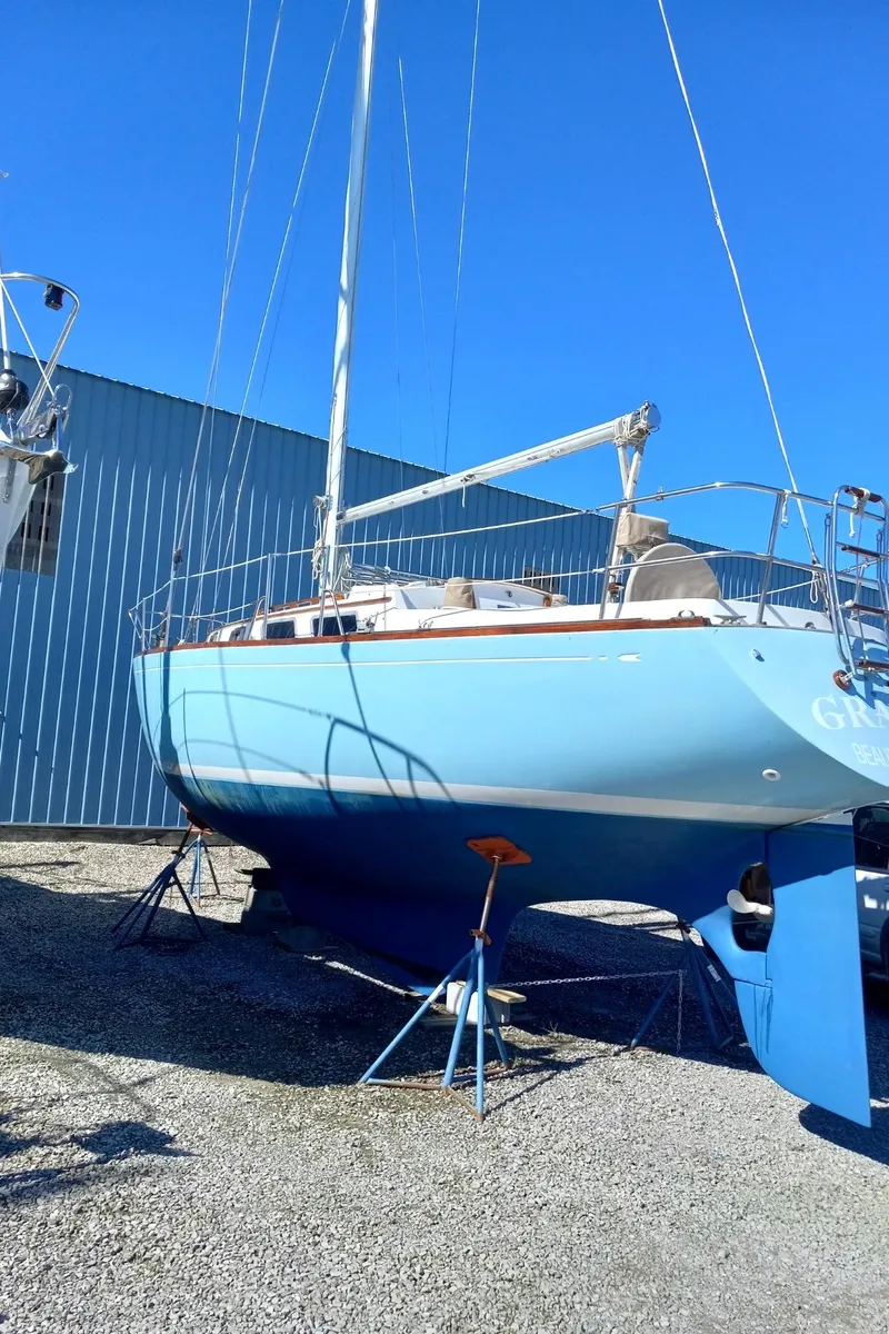 Slide: The Image of 1980 Bristol 35.5 sailboat on stands, blue hull, outdoor storage. - 17