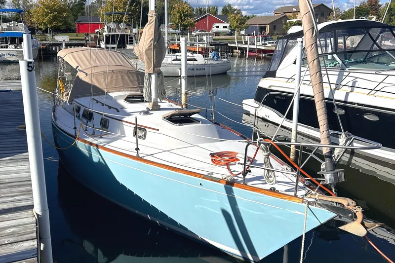 Slide: The Image of 1980 Bristol 35.5 sailboat docked in a marina, surrounded by other boats. - 2