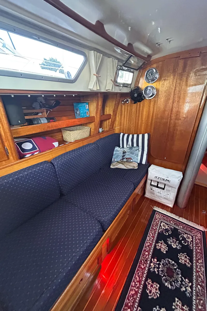 Slide: The Image of Interior of 1980 Bristol 35.5 sailboat with cozy seating and nautical decor. - 8
