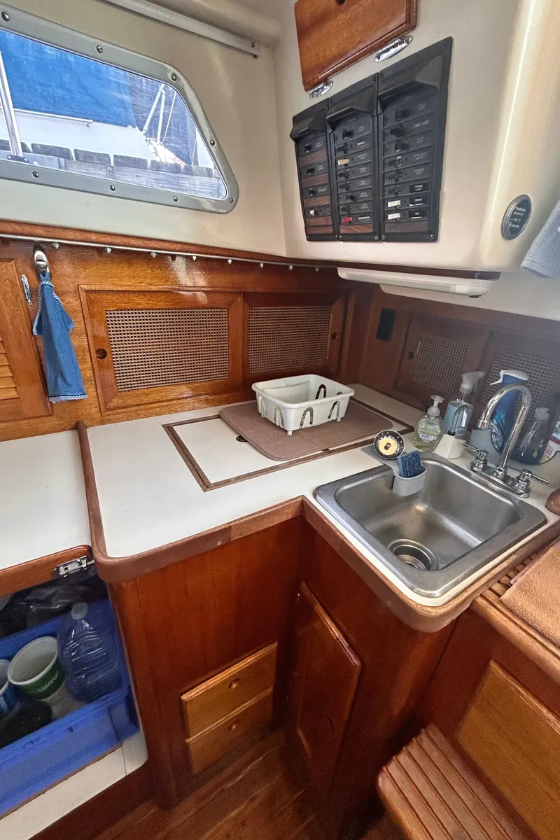 Slide: The Image of 1980 Bristol 35.5 yacht kitchen with wooden cabinetry and stainless steel sink. - 9