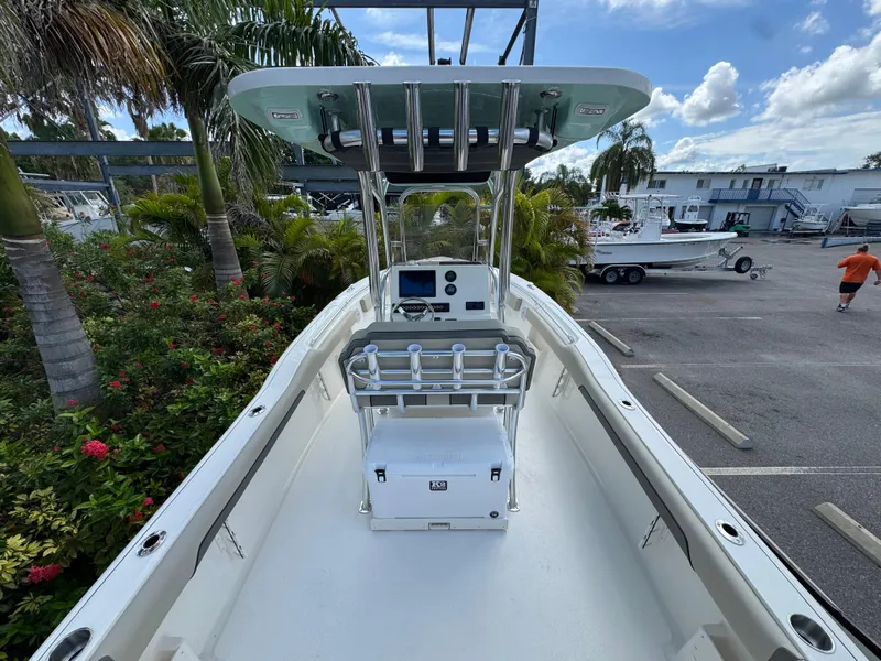 Slide: The Image of 2025 Key West 239 FS boat with center console, docked near tropical plants. - 11