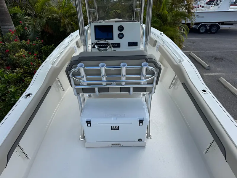 Slide: The Image of 2025 Key West 239 FS boat interior with console, rod holders, and cooler. - 13
