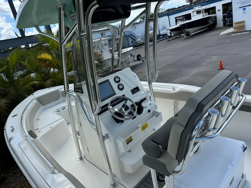 Slide: The Image of 2025 Key West 239 FS boat interior with steering console and seating. - 15