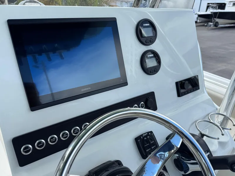 Slide: The Image of 2025 Key West 239 FS boat dashboard with Garmin display and Yamaha controls. - 17