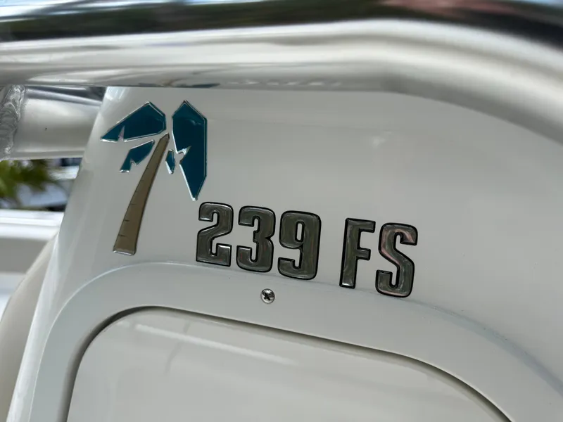 Slide: The Image of 2025 Key West 239 FS boat emblem with palm tree logo. - 19