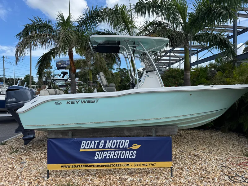 The Image of 2025 Key West 239 FS boat displayed at Boat & Motor Superstores, surrounded by palm trees. - 2