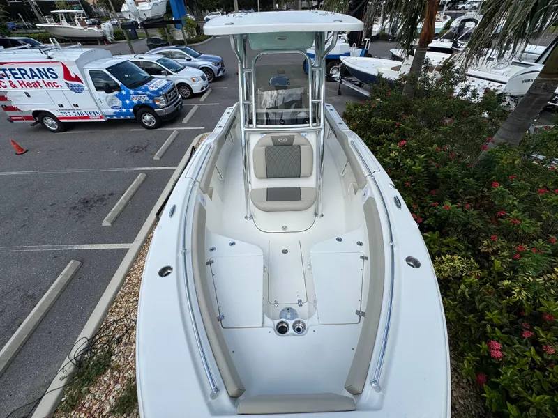 Slide: The Image of 2025 Key West 239 FS boat in parking lot, surrounded by greenery and vehicles. - 21