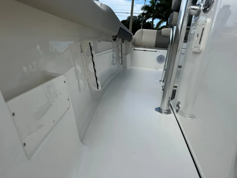 Slide: The Image of 2025 Key West 239 FS boat interior, featuring sleek white design and modern seating. - 24
