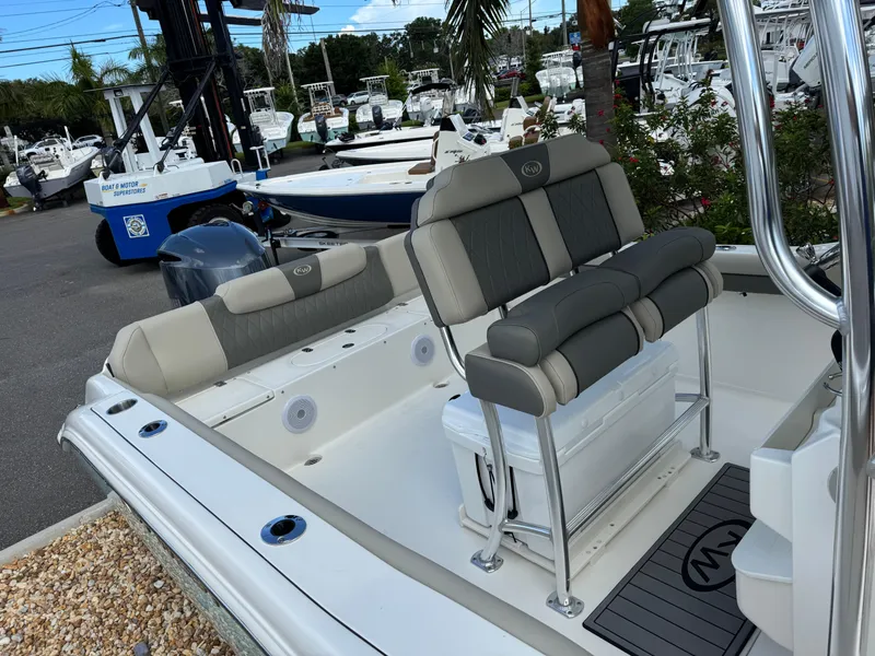 Slide: The Image of 2025 Key West 239 FS boat interior with seating and storage, displayed at a dealership. - 26
