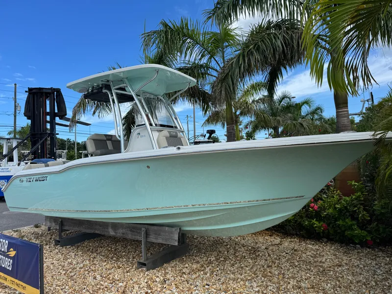 Slide: The Image of 2025 Key West 239 FS boat displayed outdoors with palm trees in the background. - 3
