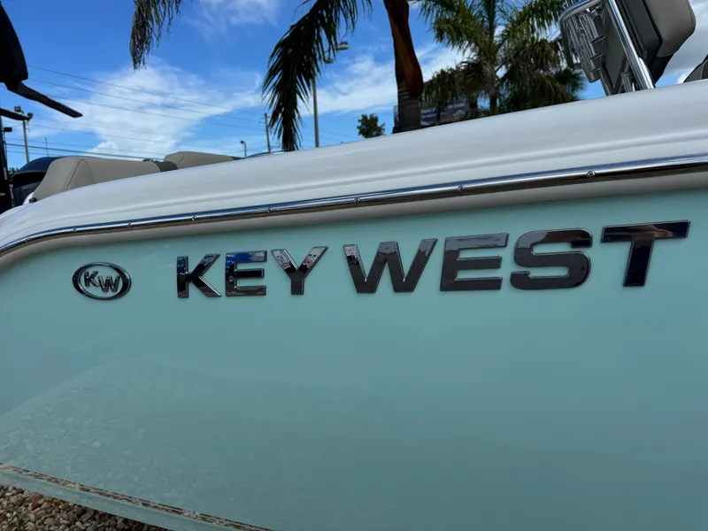 Slide: The Image of 2025 Key West 239 FS boat with logo, palm trees in background. - 4