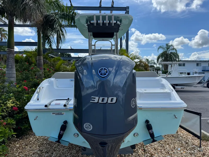 Slide: The Image of 2025 Key West 239 FS boat with Yamaha 300 engine, displayed outdoors with palm trees. - 7