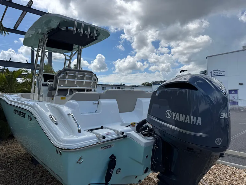 Slide: The Image of 2025 Key West 239 FS boat with Yamaha 300 engine, parked outdoors under cloudy sky. - 8