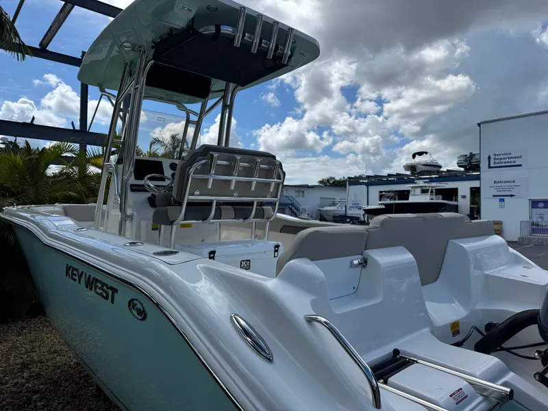Slide: The Image of 2025 Key West 239 FS boat with seating, docked under a partly cloudy sky. - 9