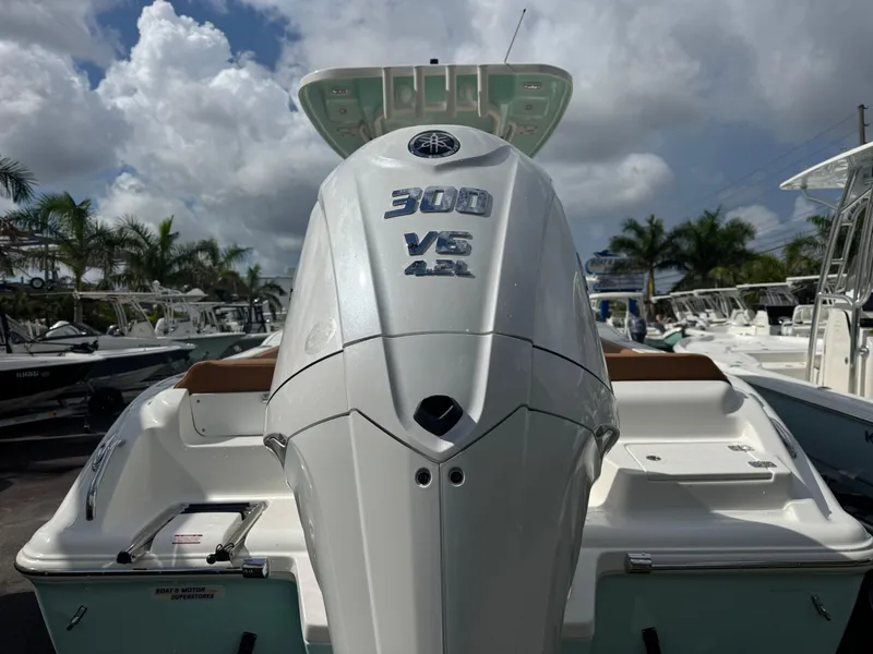 Slide: The Image of 2026 Key West 239 FSR boat with powerful 300 V6 engine, docked under cloudy sky. - 12