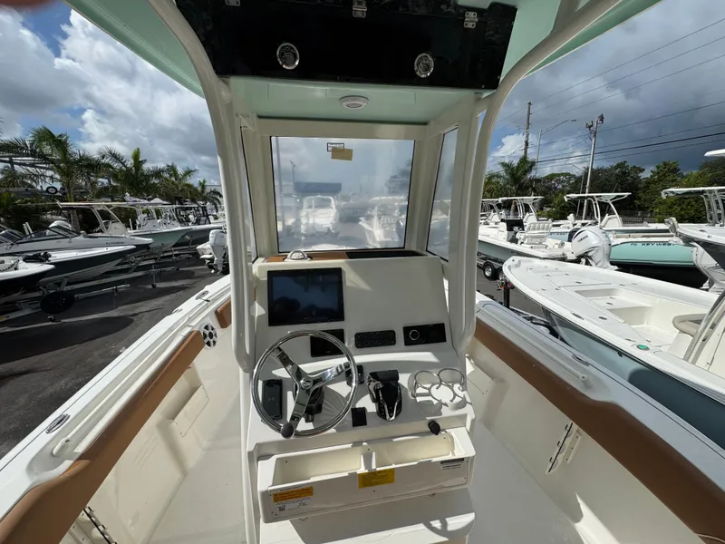Slide: The Image of Interior view of 2026 Key West 239 FSR boat, featuring steering wheel and control panel. - 20