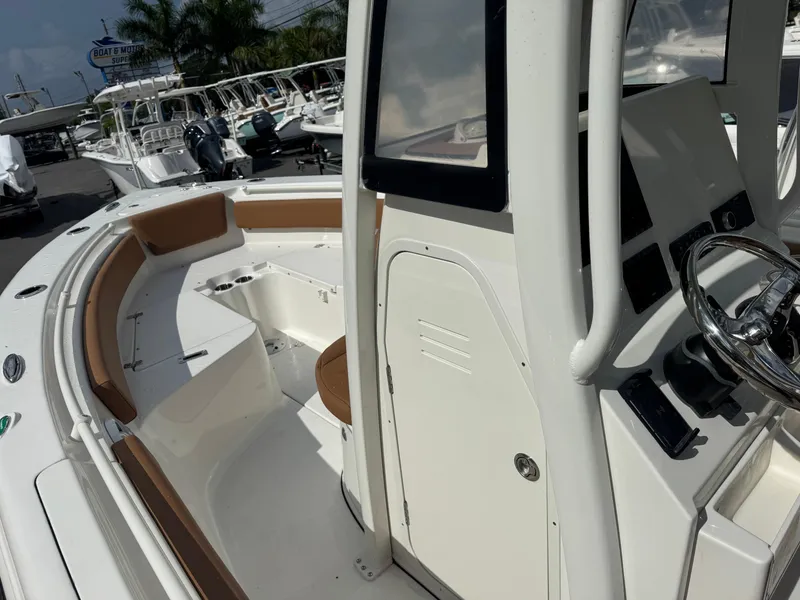 Slide: The Image of 2026 Key West 239 FSR boat interior with seating and steering console. - 21