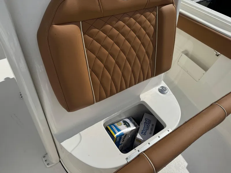 Slide: The Image of 2026 Key West 239 FSR boat seat with storage compartment, containing a HoseCoil box. - 27