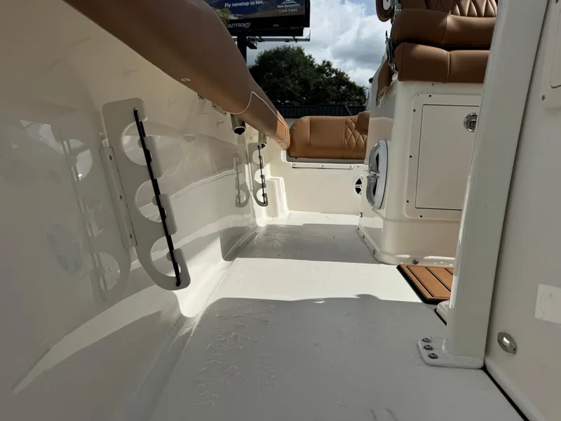Slide: The Image of 2026 Key West 239 FSR boat interior with tan seating and rod holders. - 28
