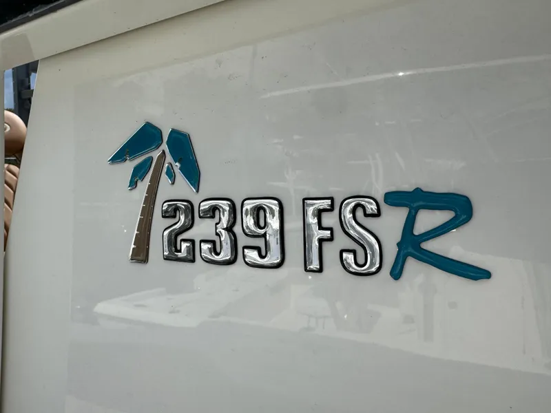 Slide: The Image of Key West 239 FSR 2026 boat logo with palm tree design. - 29