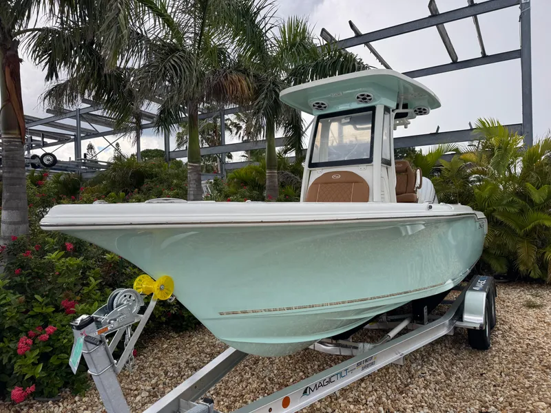 Slide: The Image of 2026 Key West 239 FSR boat on trailer, surrounded by tropical plants. - 4