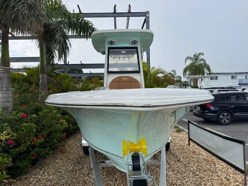 Slide: The Image of 2026 Key West 239 FSR boat displayed outdoors with tropical plants. - 5