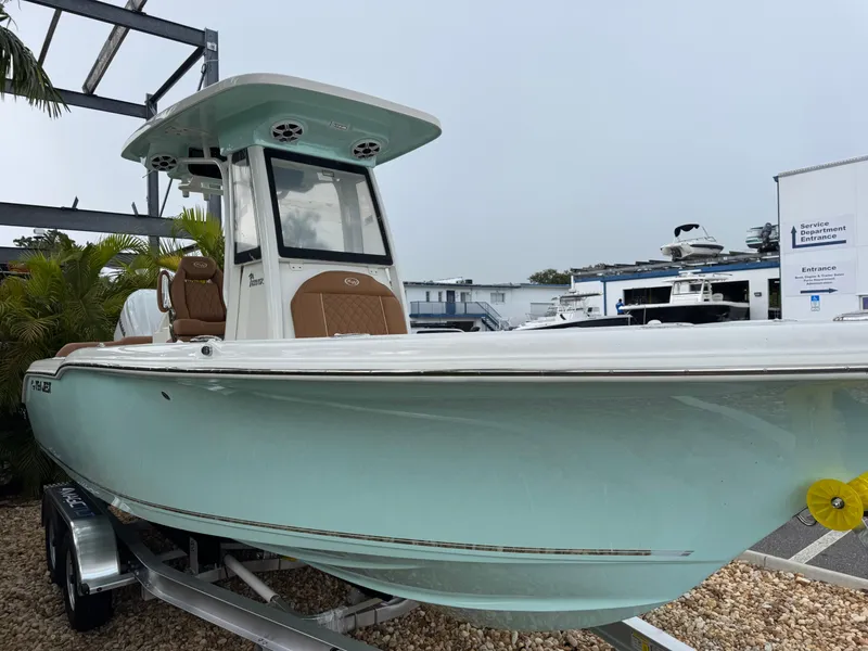 Slide: The Image of 2026 Key West 239 FSR boat on trailer, light blue hull, parked outdoors. - 6