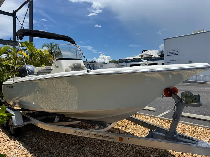 Slide: The Image of 2025 Key West 203 FS boat on trailer, parked outdoors under clear sky. - 5
