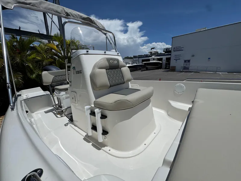 Slide: The Image of 2025 Key West 1720 Center Console boat with cushioned seating, docked outdoors. - 10