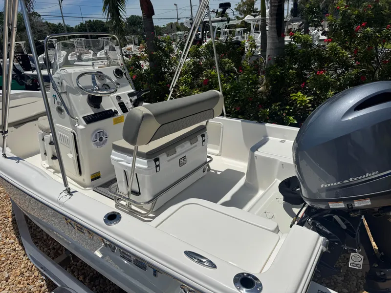 Slide: The Image of 2025 Key West 1720 Center Console boat with four-stroke engine, parked outdoors. - 17