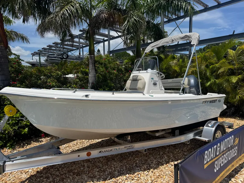 Slide: The Image of 2025 Key West 1720 Center Console boat on display, surrounded by tropical plants. - 3