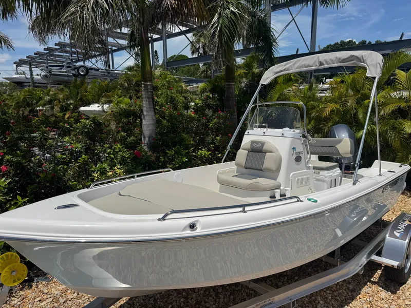 Slide: The Image of 2025 Key West 1720 Center Console boat displayed outdoors with lush greenery. - 4