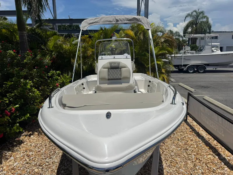 Slide: The Image of 2025 Key West 1720 Center Console boat displayed outdoors with lush greenery. - 5
