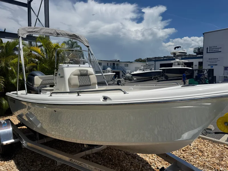 Slide: The Image of 2025 Key West 1720 Center Console boat on trailer, outdoor dealership setting. - 6
