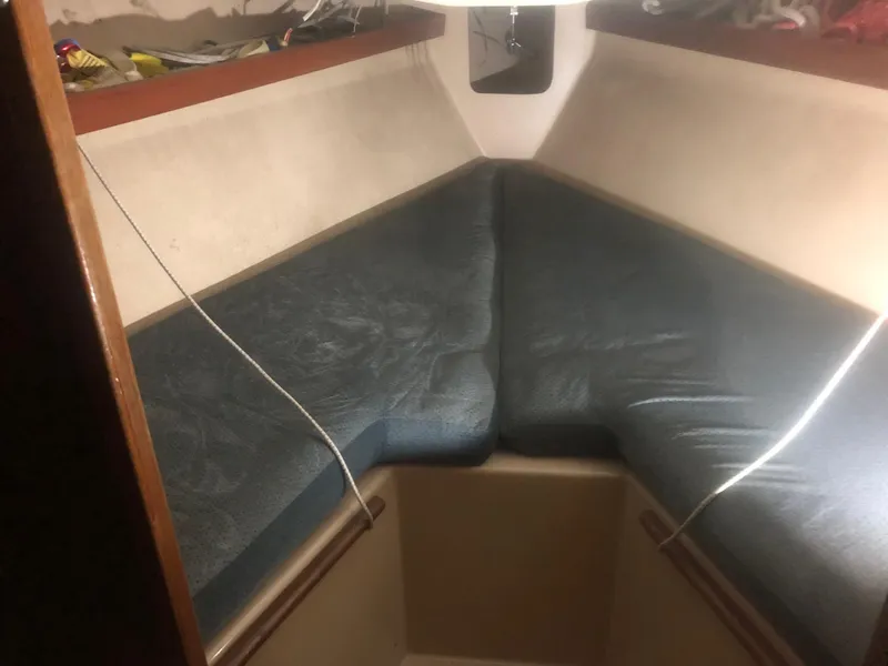 Slide: The Image of Interior of a 1979 C&C 29 sailboat with blue V-berth cushions. - 10