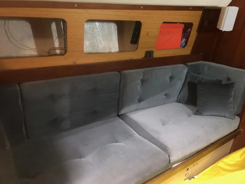 Slide: The Image of Interior of a 1979 C&C 29 sailboat with a cushioned seating area. - 8