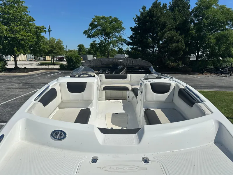 Slide: The Image of 2016 Tahoe 2150 boat with spacious seating, parked outdoors on a sunny day. - 4