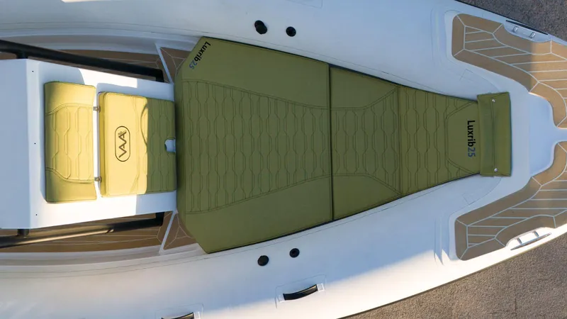 Slide: The Image of Aerial view of 2025 Aqvaboats Luxrib 25 with green seating and deck. - 13
