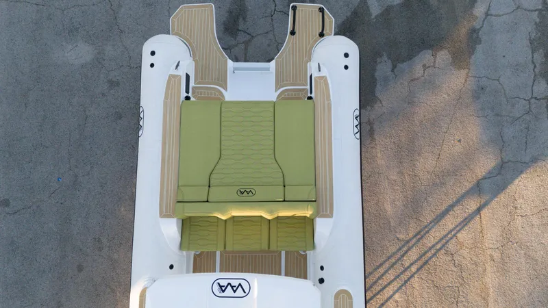 Slide: The Image of Aerial view of 2025 Aqvaboats Luxrib 25 with green seating and wooden deck accents. - 5