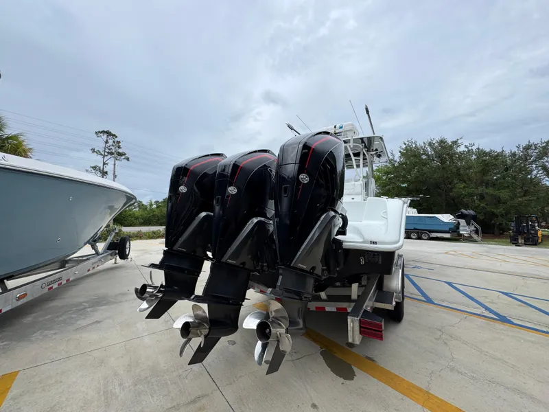Slide: The Image of 2021 Yellowfin 36 Offshore boat with triple outboard engines on a trailer. - 12