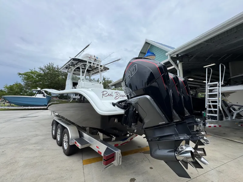 Slide: The Image of 2021 Yellowfin 36 Offshore boat with triple outboard engines on a trailer. - 14