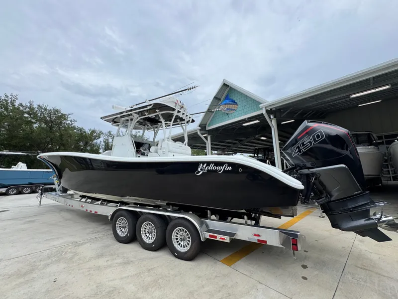 Slide: The Image of 2021 Yellowfin 36 Offshore boat on trailer, parked outside a marina. - 15