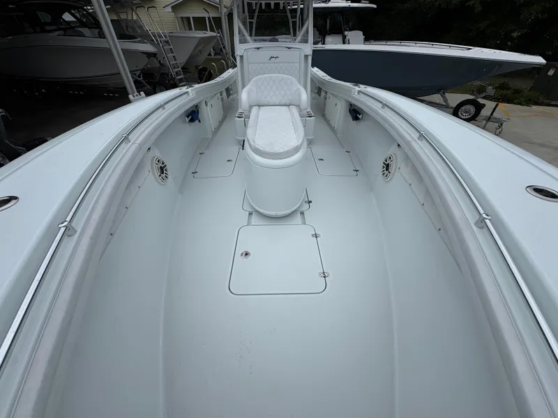 Slide: The Image of 2021 Yellowfin 36 Offshore boat interior with white seating and spacious deck. - 19