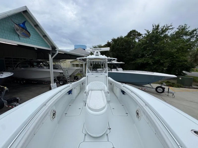 Slide: The Image of 2021 Yellowfin 36 Offshore boat docked, featuring spacious deck and Garmin equipment. - 20