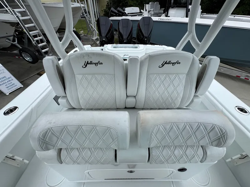 Slide: The Image of 2021 Yellowfin 36 Offshore boat with luxurious white seating and triple outboard engines. - 27