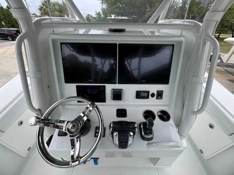 Slide: The Image of 2021 Yellowfin 36 Offshore boat console with dual screens and steering wheel. - 29
