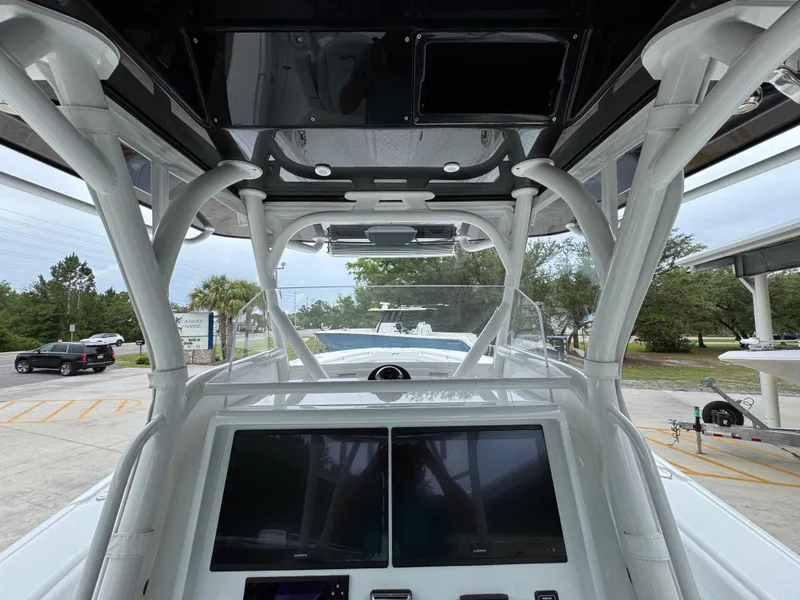 Slide: The Image of 2021 Yellowfin 36 Offshore boat interior with advanced navigation screens and sturdy framework. - 30