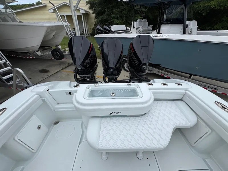 Slide: The Image of 2021 Yellowfin 36 Offshore boat with triple outboard engines, docked at a marina. - 36