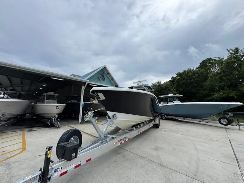 Slide: The Image of 2021 Yellowfin 36 Offshore boat on trailer at a marina, under cloudy skies. - 4