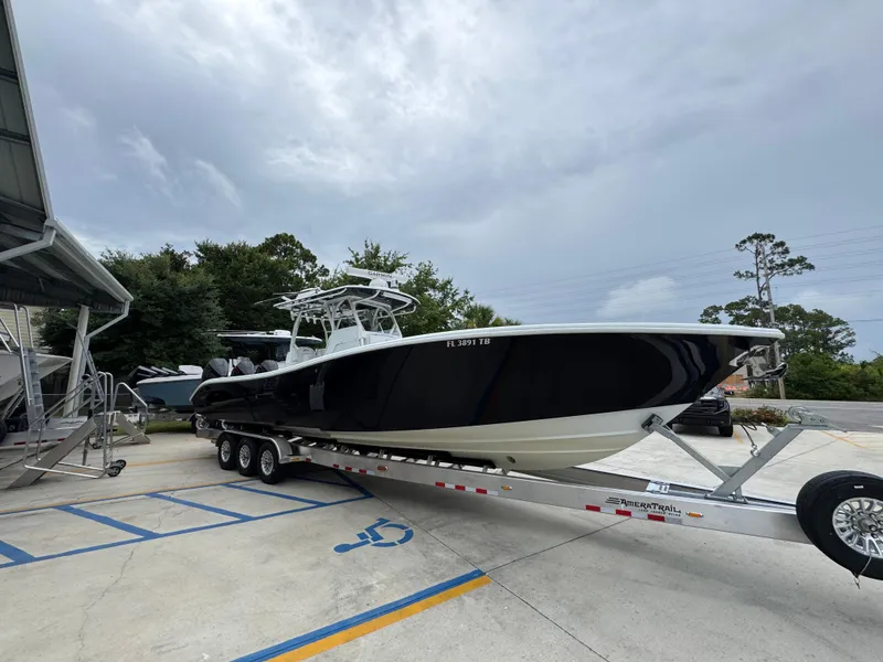 Slide: The Image of 2021 Yellowfin 36 Offshore boat on trailer, parked outdoors under cloudy sky. - 7